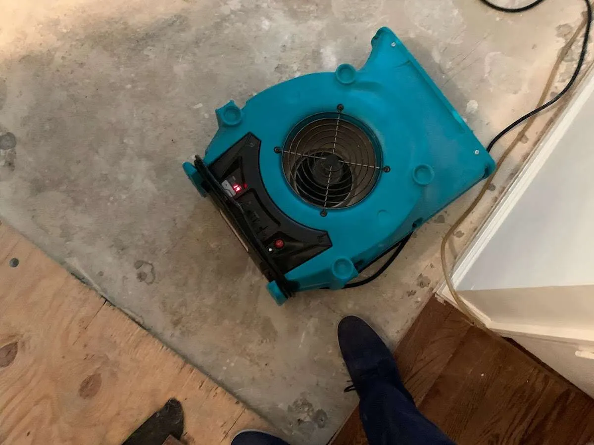 Air mover drying subfloor during Leak Detection & Repair in Ames